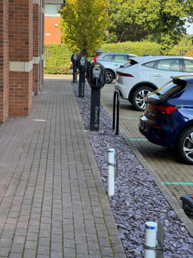 Row of workplace EV chargers beside parking bays at Alexandra House