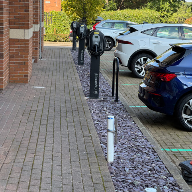 Row of workplace EV chargers beside parking bays at Alexandra House