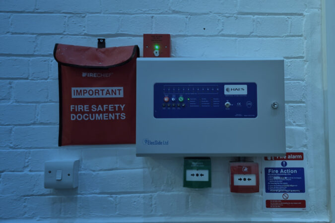 Fire alarm control panel and fire safety document pouch