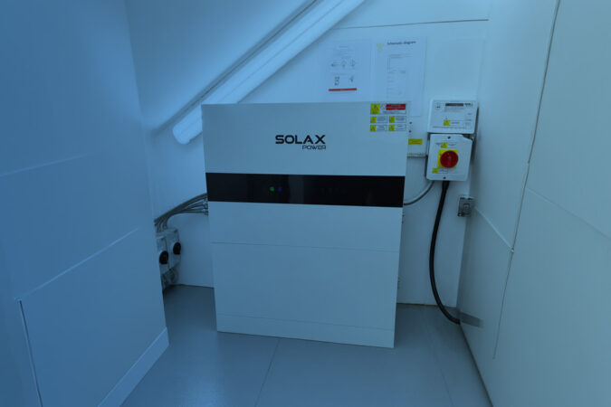 SolaX battery storage system mounted on an indoor wall