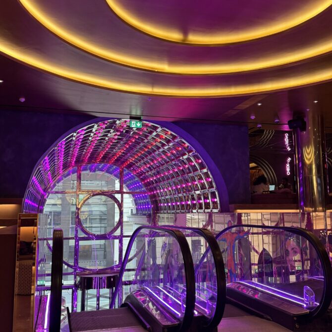 Circular ceiling lighting above the Moxy hotel reception area
