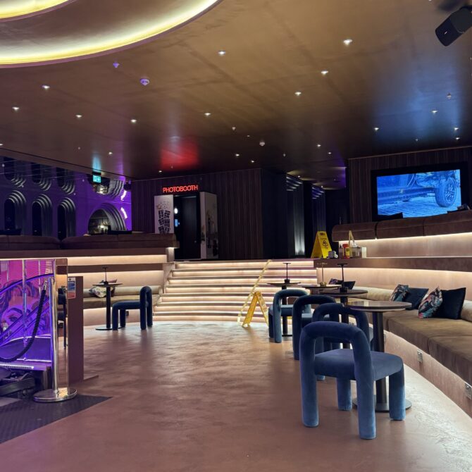 Reception counter and recessed ceiling lights at Moxy London Piccadilly Circus