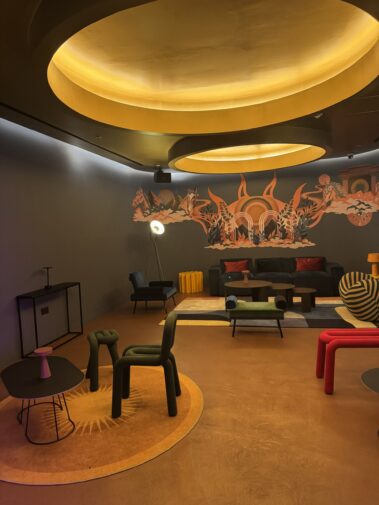 Warm circular ceiling lighting in the Moxy hotel lounge