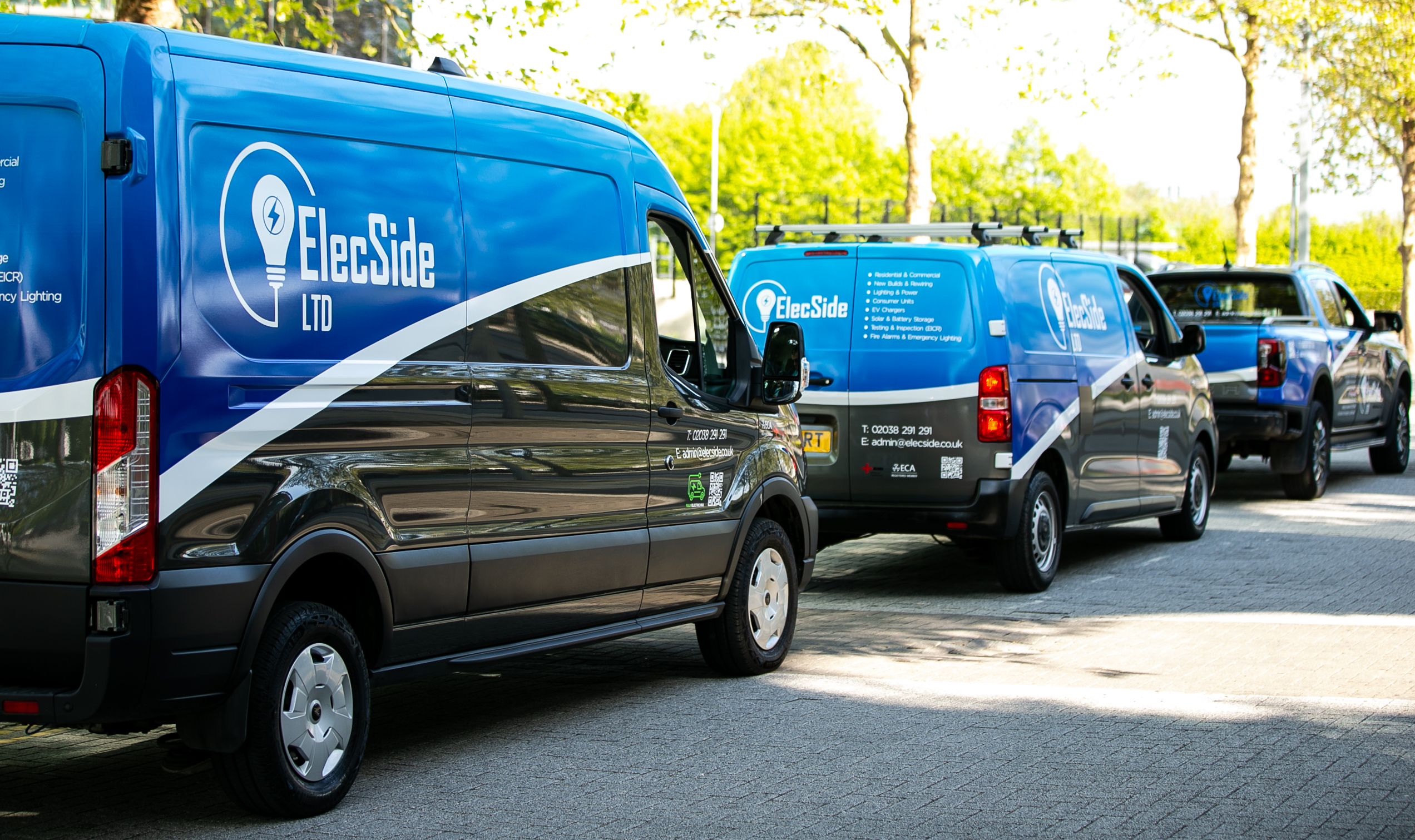 Elec Side branded vans parked outside