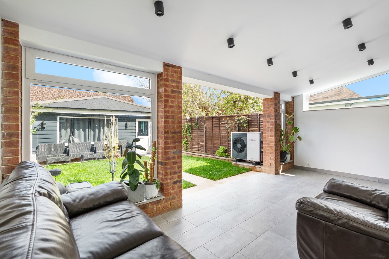 Garden room at 6 Peters Avenue with ceiling spotlights and open doors to the garden