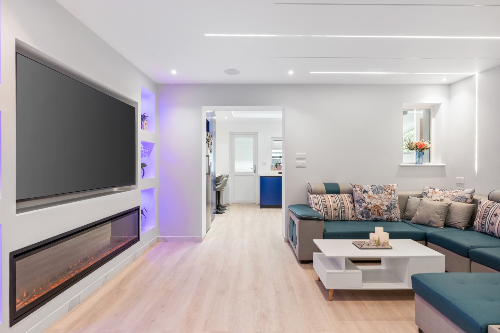 Living room at 6 Peters Avenue with recessed ceiling lights and illuminated shelving