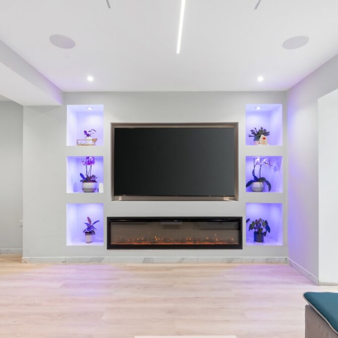 Living-room television wall with illuminated display shelves at 6 Peters Avenue