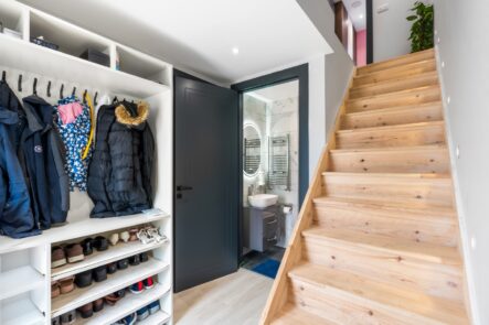 Hallway storage beside a timber staircase at 6 Peters Avenue