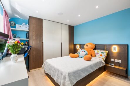 Blue bedroom with fitted wardrobes and ceiling downlights at 6 Peters Avenue